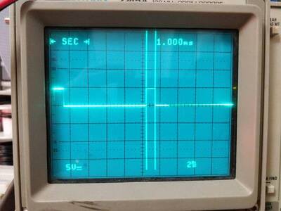 The oscilloscope screen showing that the square wave is high for 1 ms per period.
