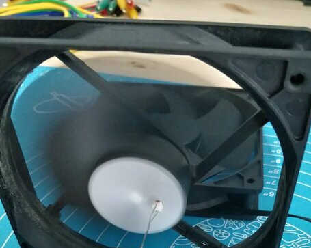 Fan running with photoresistor held in front of the spinning paper pattern.